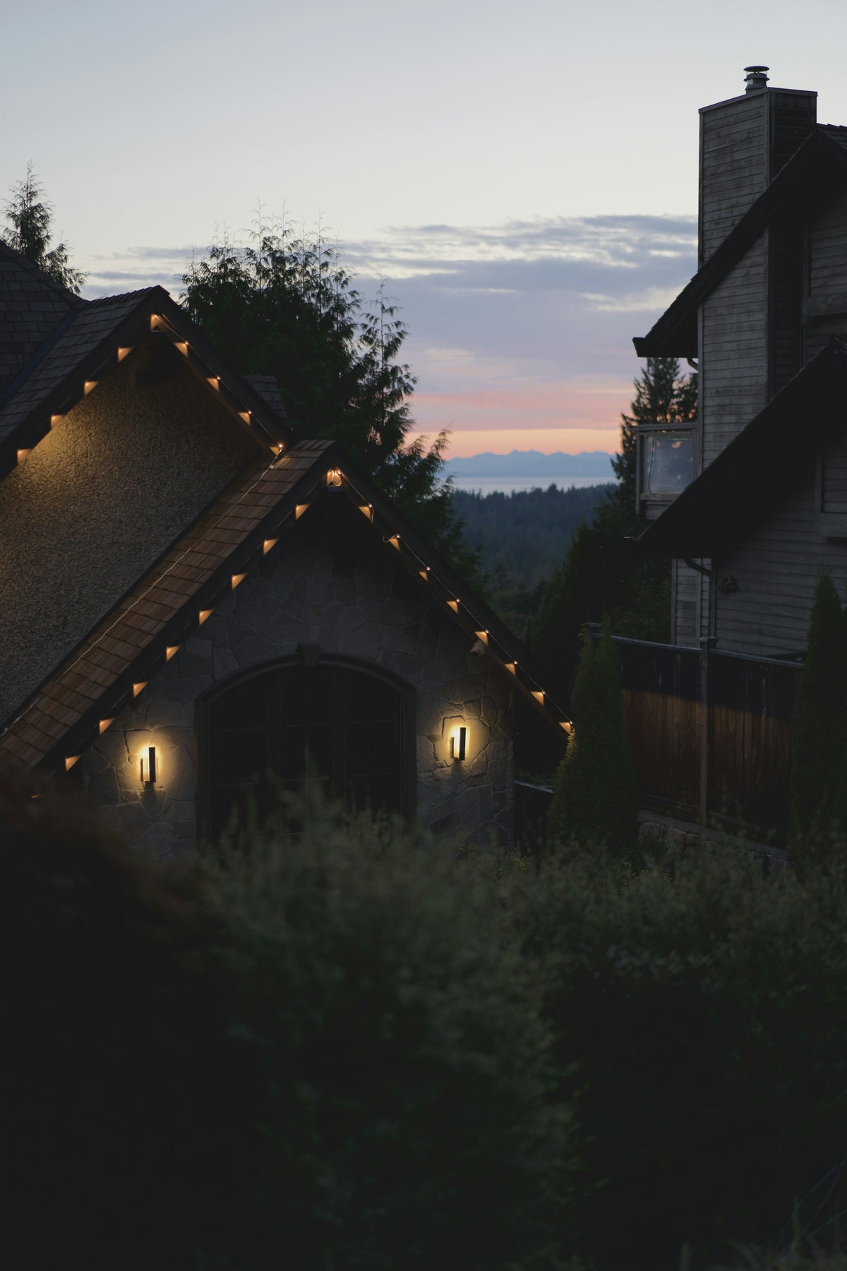 Stone house with glowing windows at dusk